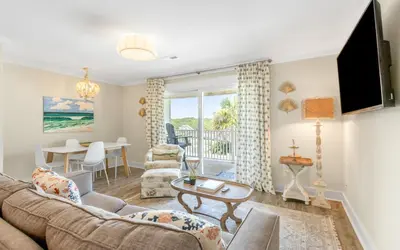 a living room with a couch and a table at Shoreline 9 Unit 5 by Oversee 30A in Inlet Beach