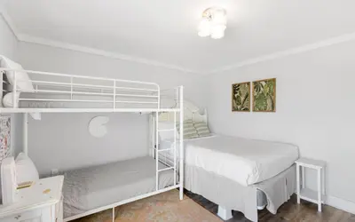 a bedroom with two bunk beds and a desk at Shoreline 9 Unit 5 by Oversee 30A in Inlet Beach