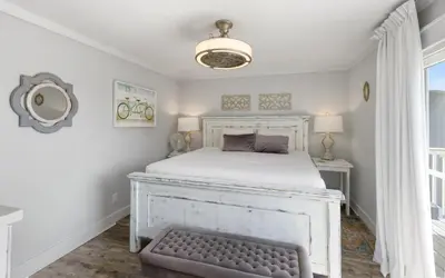 a bedroom with a white bed and a window at Shoreline 9 Unit 5 by Oversee 30A in Inlet Beach