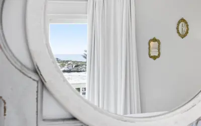 a mirror in a room with a view of the ocean at Shoreline 9 Unit 5 by Oversee 30A in Inlet Beach