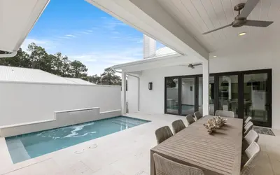a dining room with a table and a swimming pool at Slim Shady by Oversee 30A in Santa Rosa Beach