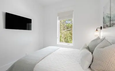 a white bedroom with a bed and a window at Slim Shady by Oversee 30A in Santa Rosa Beach