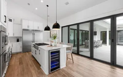 a kitchen with white cabinets and a island with a counter top at Slim Shady by Oversee 30A in Santa Rosa Beach