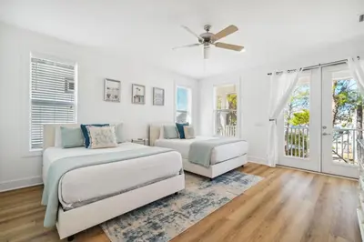 a bedroom with two beds and a ceiling fan at Sound Waves Getaways by Oversee 30A in Rosemary Beach