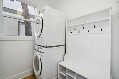 a white laundry room with a washer and dryer at Sound Waves Getaways by Oversee 30A in Rosemary Beach