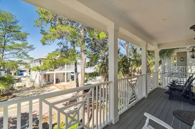 a porch with a view of the beach at Sound Waves Getaways by Oversee 30A in Rosemary Beach