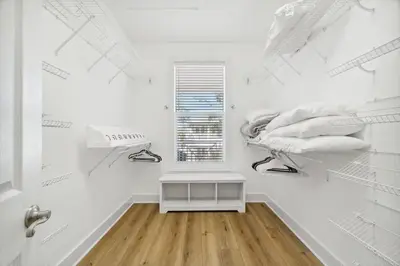 a room with white walls and a white closet with shelves at Sound Waves Getaways by Oversee 30A in Rosemary Beach