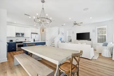 a kitchen and living room with a table and chairs at Sound Waves Getaways by Oversee 30A in Rosemary Beach