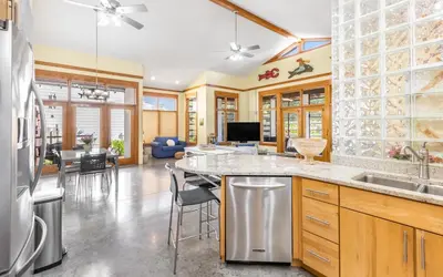a kitchen with a counter and a living room at Special Purpose by Oversee 30A in Santa Rosa Beach