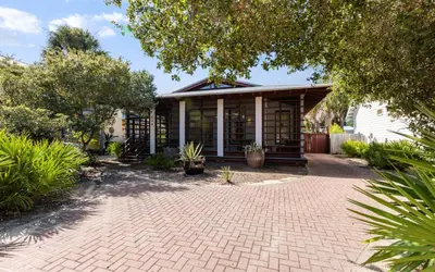 a house with a brick driveway in front of a building at Special Purpose by Oversee 30A in Santa Rosa Beach