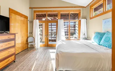 a bedroom with a large bed and a television at Special Purpose by Oversee 30A in Santa Rosa Beach