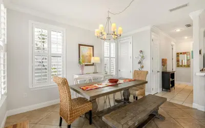 a dining room with a table and chairs at Splish Splash by Oversee 30A in Seacrest