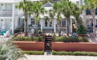 a house with palm trees in front of it at Splish Splash by Oversee 30A in Seacrest
