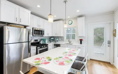 a kitchen with white cabinets and a white counter top at Sun Palace by Oversee 30A in Santa Rosa Beach