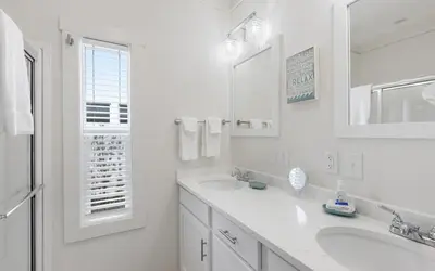 a white bathroom with two sinks and a mirror at Sun Palace by Oversee 30A in Santa Rosa Beach