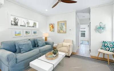 a living room with a blue couch and a table at Sun Palace by Oversee 30A in Santa Rosa Beach