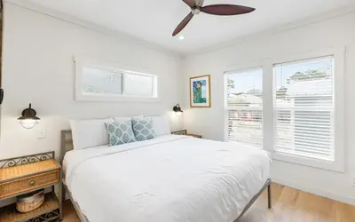 a white bedroom with a bed and a window at Sun Palace by Oversee 30A in Santa Rosa Beach