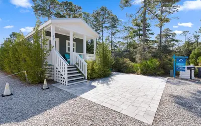 a small cottage with a porch and a driveway at Sun Palace by Oversee 30A in Santa Rosa Beach