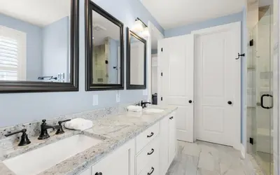 a white bathroom with two sinks and a shower at Sunseeker by Oversee 30A in Santa Rosa Beach
