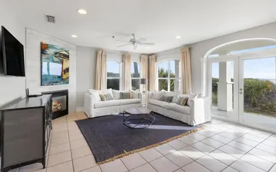 a living room with two white couches and a fireplace at Sunset Beach Villa A101 by Oversee 30A in Rosemary Beach