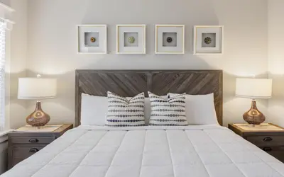 a bedroom with a large white bed with two lamps at Sunset Beach Villa A101 by Oversee 30A in Rosemary Beach