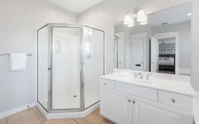 a white bathroom with a shower and a sink at Sunset Beach Villa A101 by Oversee 30A in Rosemary Beach