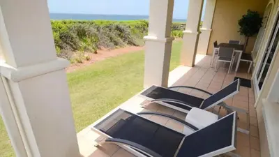 a porch with chairs and a view of the ocean at Sunset Beach Villa A101 by Oversee 30A in Rosemary Beach