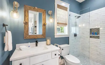 a bathroom with a sink and a toilet and a mirror at Surfing Cowboy by Oversee 30A in Santa Rosa Beach