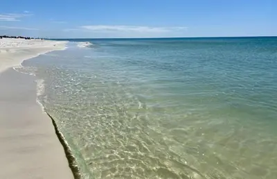 a beach with the ocean and the water at Surfing Cowboy by Oversee 30A in Santa Rosa Beach