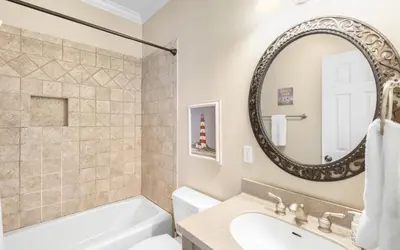 a bathroom with a tub and a sink and a mirror at The Fab Crab by Oversee 30A in Seacrest
