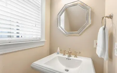 a bathroom with a sink and a mirror at The Fab Crab by Oversee 30A in Seacrest