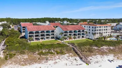 an aerial view of a resort on the beach at The Palms by Oversee 30A in Santa Rosa Beach