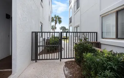a black gate in front of a building at The Palms by Oversee 30A in Santa Rosa Beach