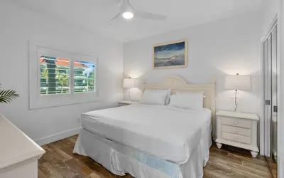 a white bedroom with a white bed and a window at The Palms by Oversee 30A in Santa Rosa Beach