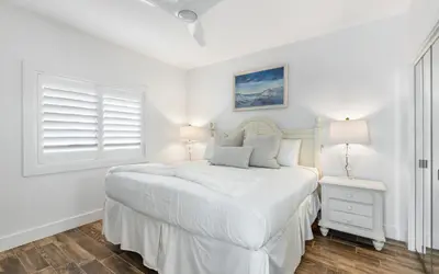 a white bedroom with a bed and a window at The Palms by Oversee 30A in Santa Rosa Beach
