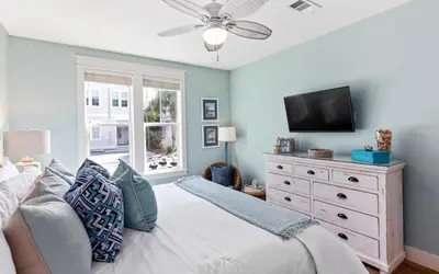 a bedroom with a bed and a tv on a dresser at The Round Up by Oversee 30A in Inlet Beach
