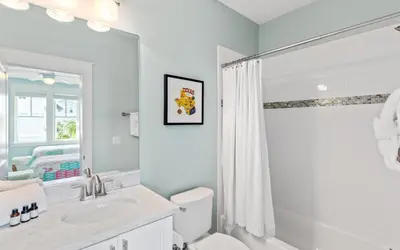 a white bathroom with a sink and a toilet at The Round Up by Oversee 30A in Inlet Beach