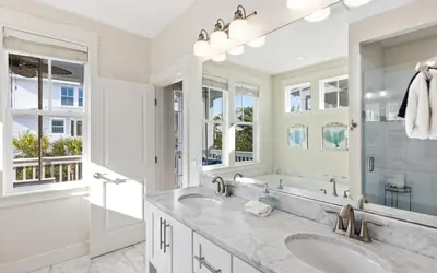 a bathroom with two sinks and a large mirror at The Round Up by Oversee 30A in Inlet Beach