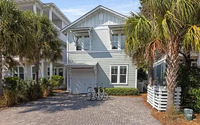 a white house with bikes parked in front of it at The Round Up by Oversee 30A in Inlet Beach