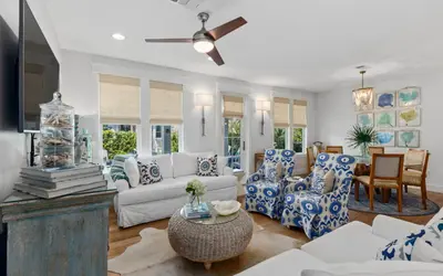 a living room with blue and white furniture and a ceiling fan at The Round Up by Oversee 30A in Inlet Beach