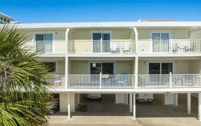 a large yellow building with white balconies at Tucked-Away at Inlet Beach by Oversee 30A in Inlet Beach