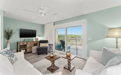 a living room with a white couch and a tv at Tucked-Away at Inlet Beach by Oversee 30A in Inlet Beach