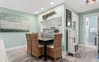 a kitchen with a dining room table and chairs at Tucked-Away at Inlet Beach by Oversee 30A in Inlet Beach