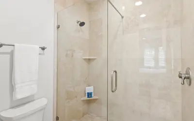 a bathroom with a shower with a glass door at Two Rocking Chairs on a Porch by Oversee 30A in Watersound Beach