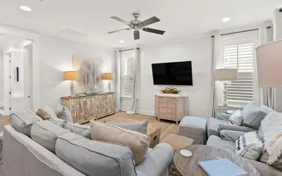 a living room with two couches and a flat screen tv at Two Rocking Chairs on a Porch by Oversee 30A in Watersound Beach