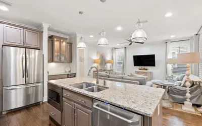 a kitchen with a sink and a living room at Two Rocking Chairs on a Porch by Oversee 30A in Watersound Beach