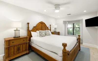 a bedroom with a large bed and a television at Villa Bon Secour by Oversee 30A in Seacrest