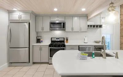 a kitchen with white cabinets and a white counter top at Villa Bon Secour by Oversee 30A in Seacrest