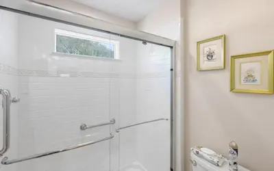 a bathroom with a glass shower with a toilet at Villa Del Lago by Oversee 30A in Seacrest