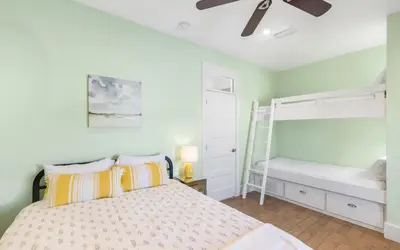 a bedroom with a bed and a bunk bed at Winters End by Oversee 30A in Santa Rosa Beach